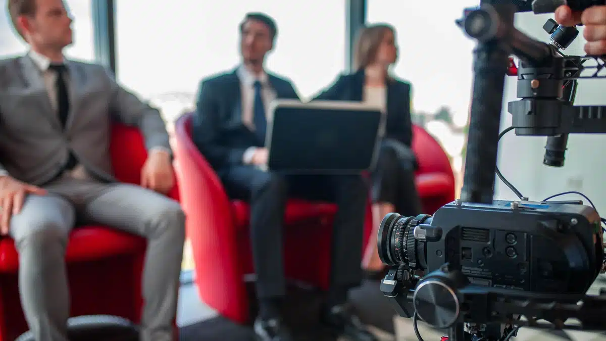 The State of Corporate Video in Denver Budgets, Turnarounds, and Formats in 2026 The state of corporate video in Denver in 2026 covers budgets, turnaround times, and popular formats. Image shows a business meeting with a camera recording the session.